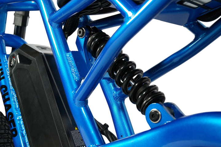 Close-up of a blue electric bike frame with suspension fork on a white background