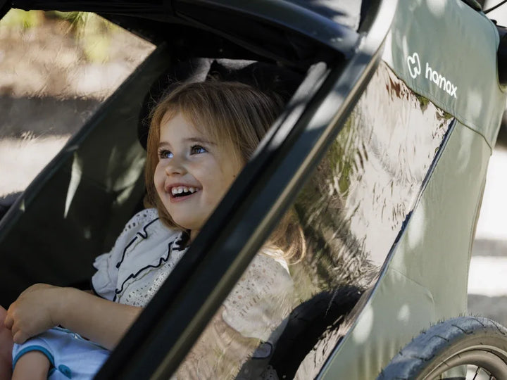 Hamax Outback Next child riding comfortably in the cabin