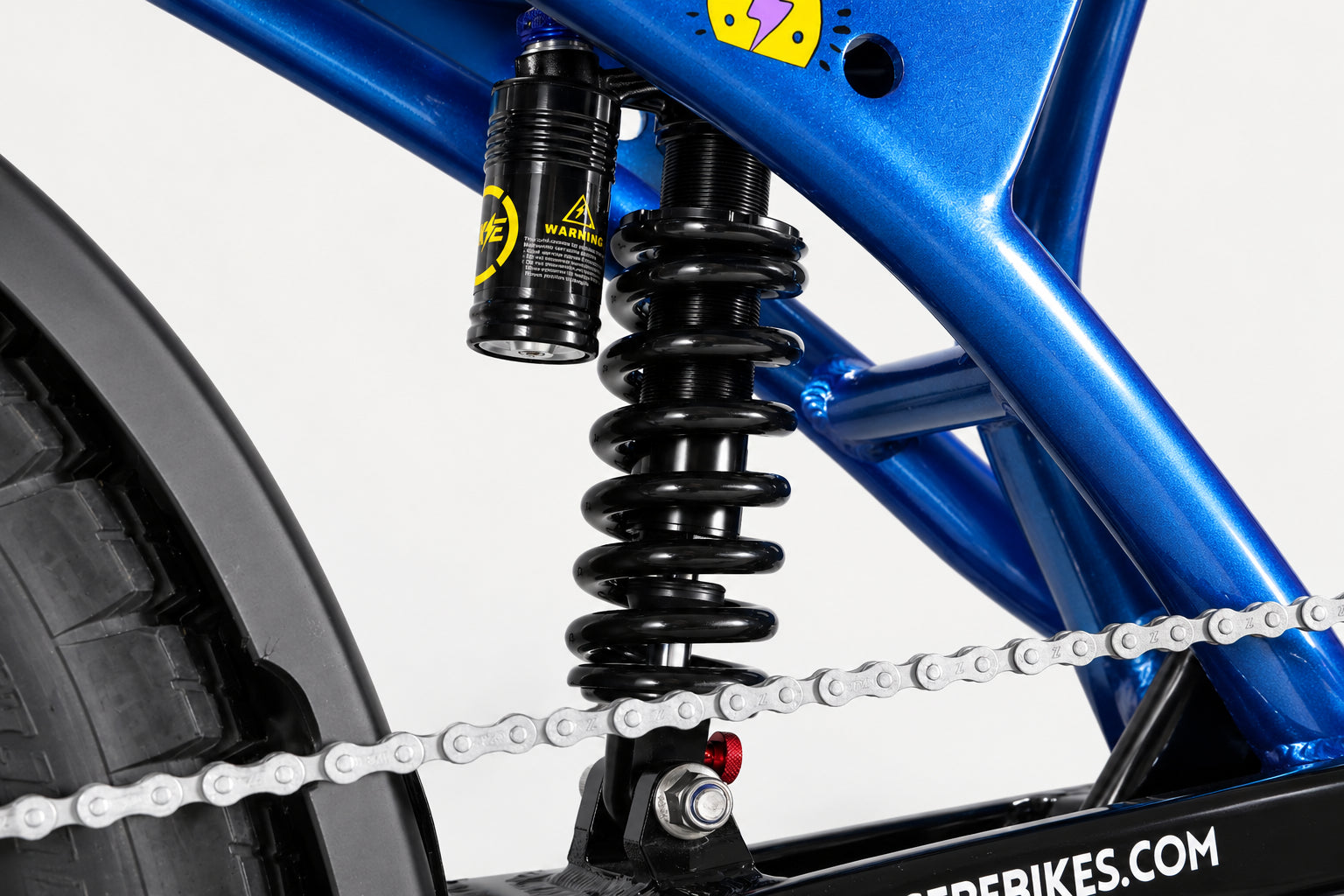 Nova V3 rear coil suspension shock in the blue frame